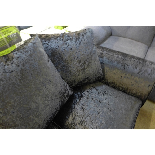 1554 - A black velvet two seater sofa