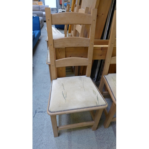 1614 - A pine dining table and a set of six ladderback chairs