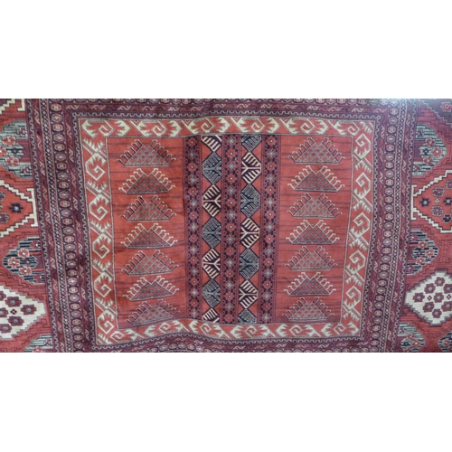 1543 - A large red ground cashmere Afghan design rug 340 x 240