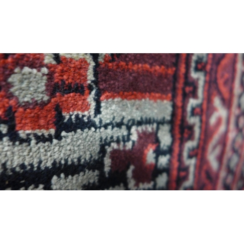 1543 - A large red ground cashmere Afghan design rug 340 x 240