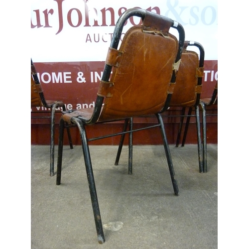 1 - A set of four Les Arcs style black metal and brown leather chairs, attributed to Charlotte Perriand