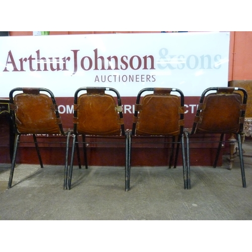 1 - A set of four Les Arcs style black metal and brown leather chairs, attributed to Charlotte Perriand