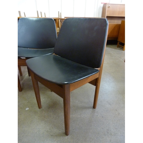 17 - A set of four Elliotts of Newbury teak and black vinyl dining chair