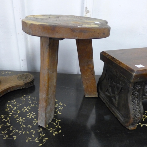 198 - A 17th Century Gothic style carved oak stool, an elm primitive stool, fruitwood clamp and a carved w... 