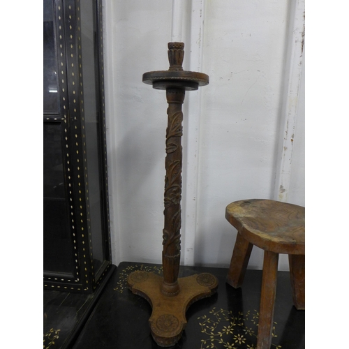 198 - A 17th Century Gothic style carved oak stool, an elm primitive stool, fruitwood clamp and a carved w... 