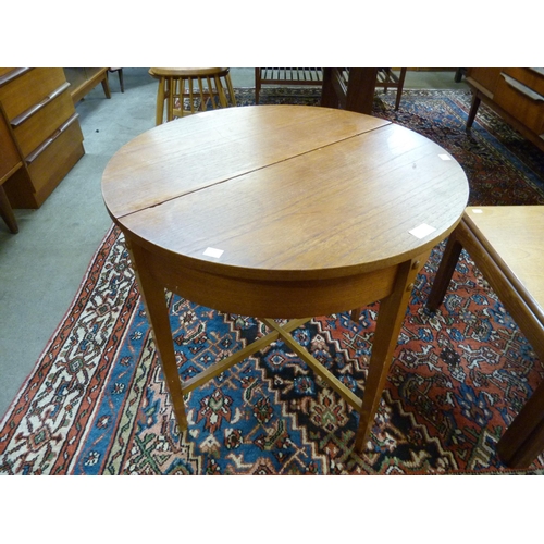 2 - A Danish teak and wicker circular sewing table