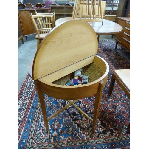 2 - A Danish teak and wicker circular sewing table