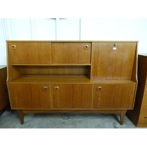 22 - A teak highboard