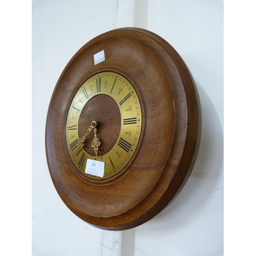 25 - A teak and brass circular wall clock