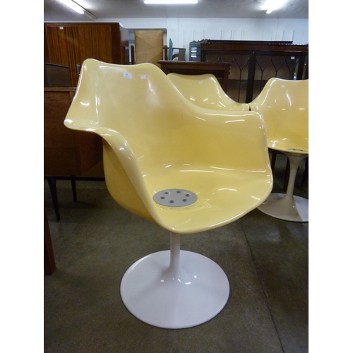 44 - A set of four Eero Saarinen style white and yellow laminate revolving chairs