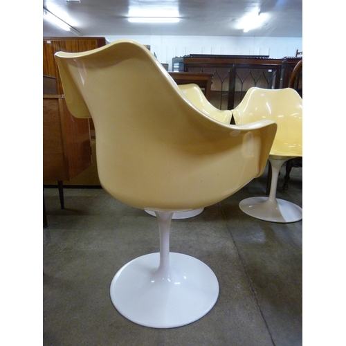 44 - A set of four Eero Saarinen style white and yellow laminate revolving chairs