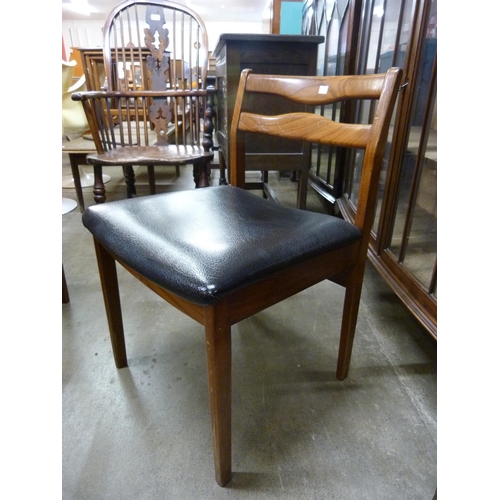 57 - A teak extending dining table and five chairs