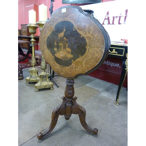 73 - A 19th Century Black Forest carved and inlaid softwood tilt top tripod table