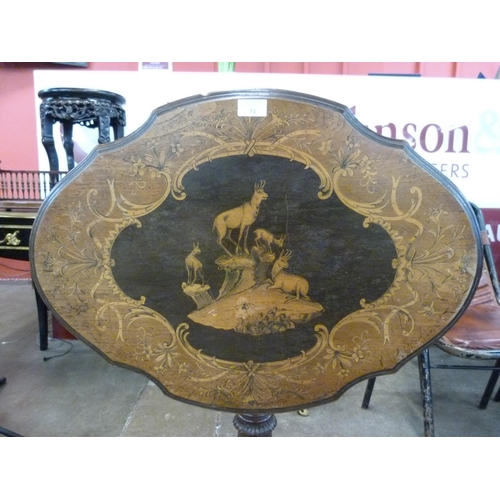 73 - A 19th Century Black Forest carved and inlaid softwood tilt top tripod table