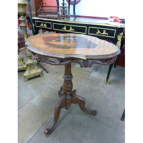 73 - A 19th Century Black Forest carved and inlaid softwood tilt top tripod table