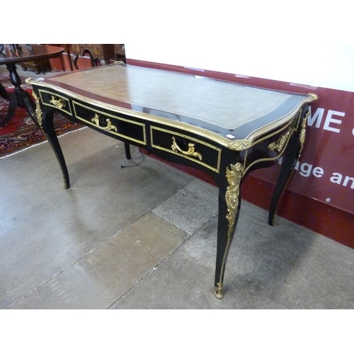 75 - A French ebonised, ormolu and green leather topped three drawer writing table