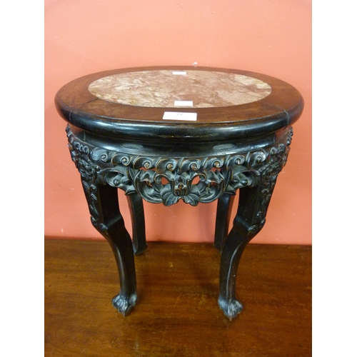 77 - A Chinese carved hardwood and marble topped jardiniere stand