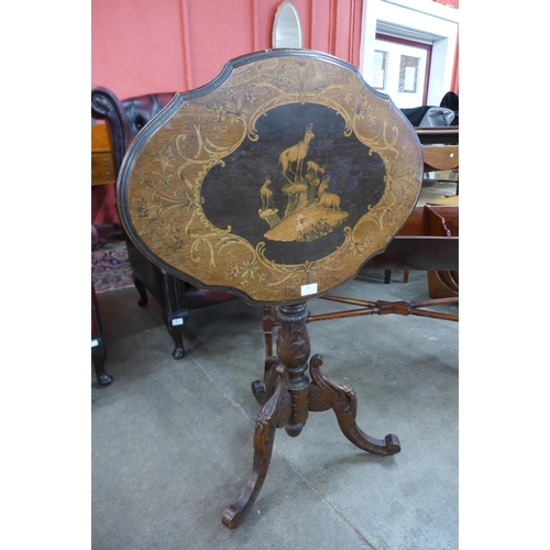 25 - A 19th Century Black Forest carved and inlaid softwood tilt top tripod table