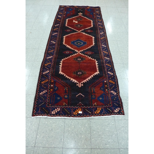 35 - A Persian red ground Hamadan runner rug, 115 x 298cms