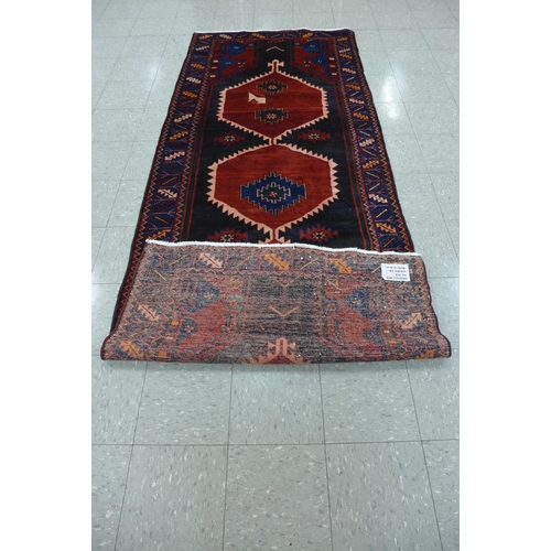 35 - A Persian red ground Hamadan runner rug, 115 x 298cms