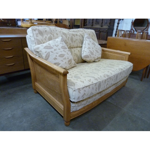 89 - An Ercol Blonde ash settee