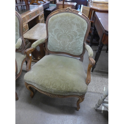 150 - A pair of French carved beech and fabric upholstered fauteuil armchairs