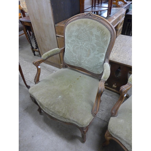 150 - A pair of French carved beech and fabric upholstered fauteuil armchairs