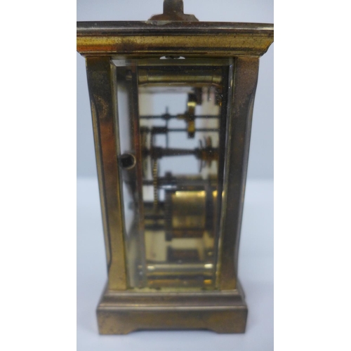 622 - A gilt brass and four glass sided carriage clock with long service inscription plaque to the front