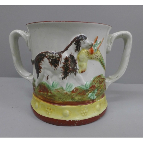 633 - A Staffordshire Pottery frog mug; two handled jug decorated with dogs and with a figure of a frog on... 