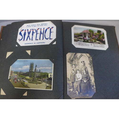 676 - A part filled album of postcards and three mint stamp packs