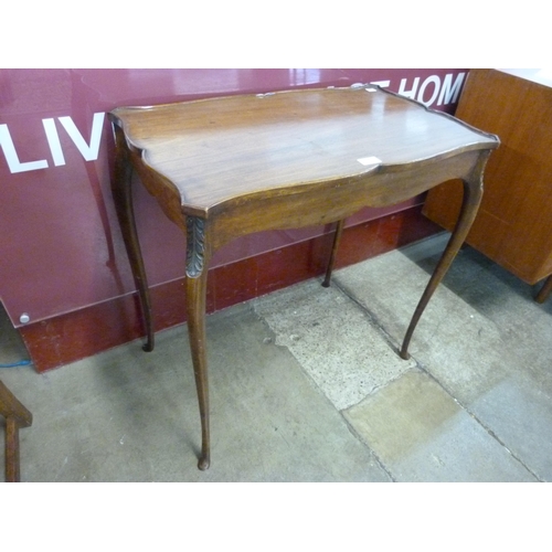 10 - A Hepplewhite style mahogany serpentine silver table