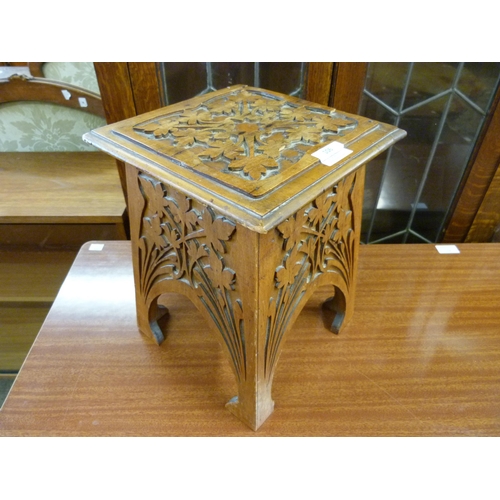 106 - A small Arts and Crafts carved oak stool