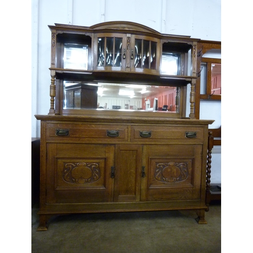 123 - An Arts and Crafts carved oak mirrorback sideboard