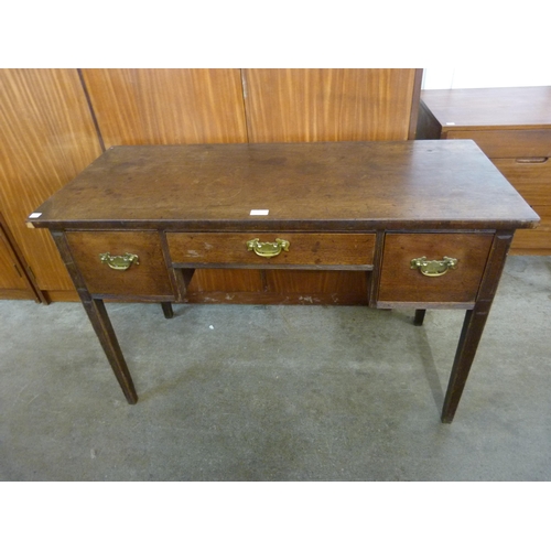 130 - A George III mahogany three drawer writing table