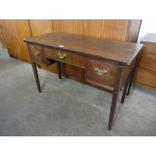 130 - A George III mahogany three drawer writing table