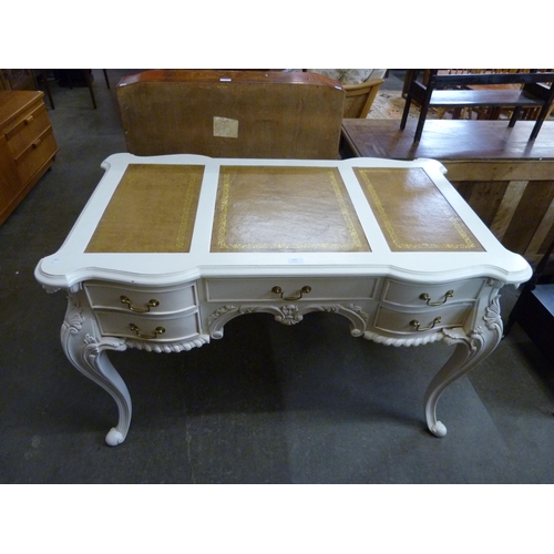 133 - A French style cream and brown leather topped partner's library desk