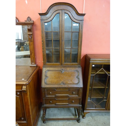 14 - An early 20th Century oak dwarf sized oak barleytwist bureau bookcase