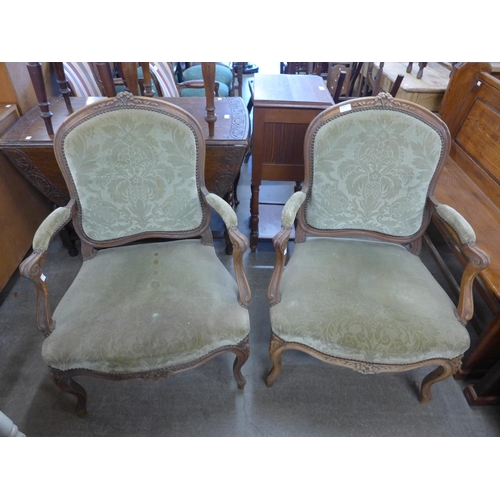 150 - A pair of French carved beech and fabric upholstered fauteuil armchairs