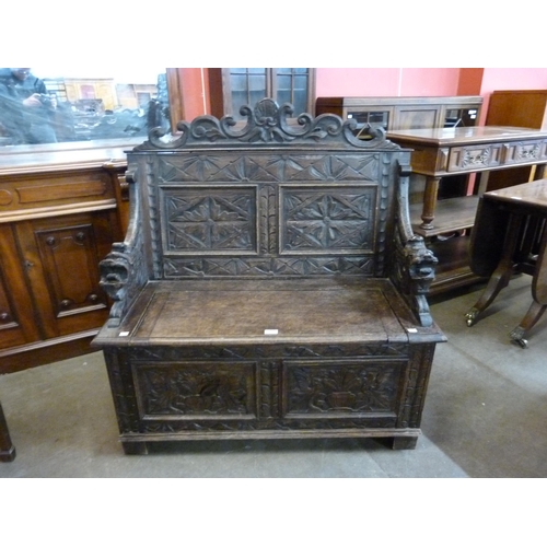 16 - A Victorian Jacobean Revival carved oak hall seat