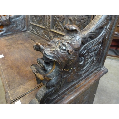 16 - A Victorian Jacobean Revival carved oak hall seat