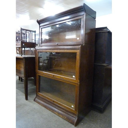 194 - An early 20th Century oak three tier sectional stacking bookcase