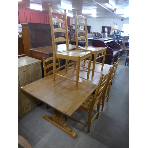 204 - An Ercol ash refectory table and six ladderback chairs