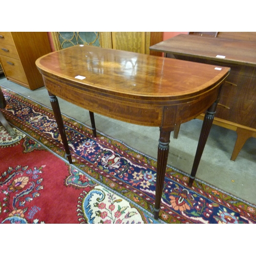 21 - A Regency inlaid mahogany demi lune fold-over games table