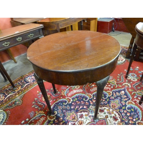 23 - A George III mahogany demi lune fold-over tea table