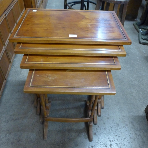 242 - A yew wood nest of quartetto tables