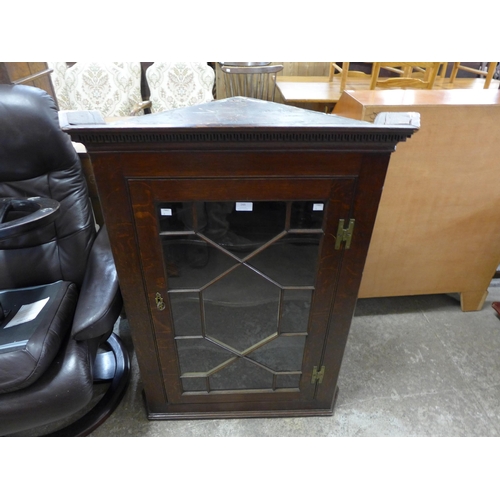 244 - A George III oak wall hanging corner cabinet