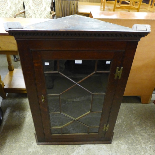 244 - A George III oak wall hanging corner cabinet