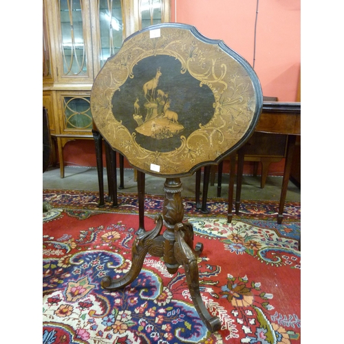 25 - A 19th Century Black Forest carved and inlaid softwood tilt top tripod table