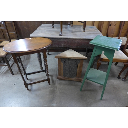 260 - An oak barleytwist oval occasional table, a painted jardiniere stand and a small corner cupboard