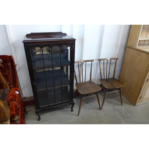 266 - A pair of Ercol dark elm and beech chairs, a bookcase and one other